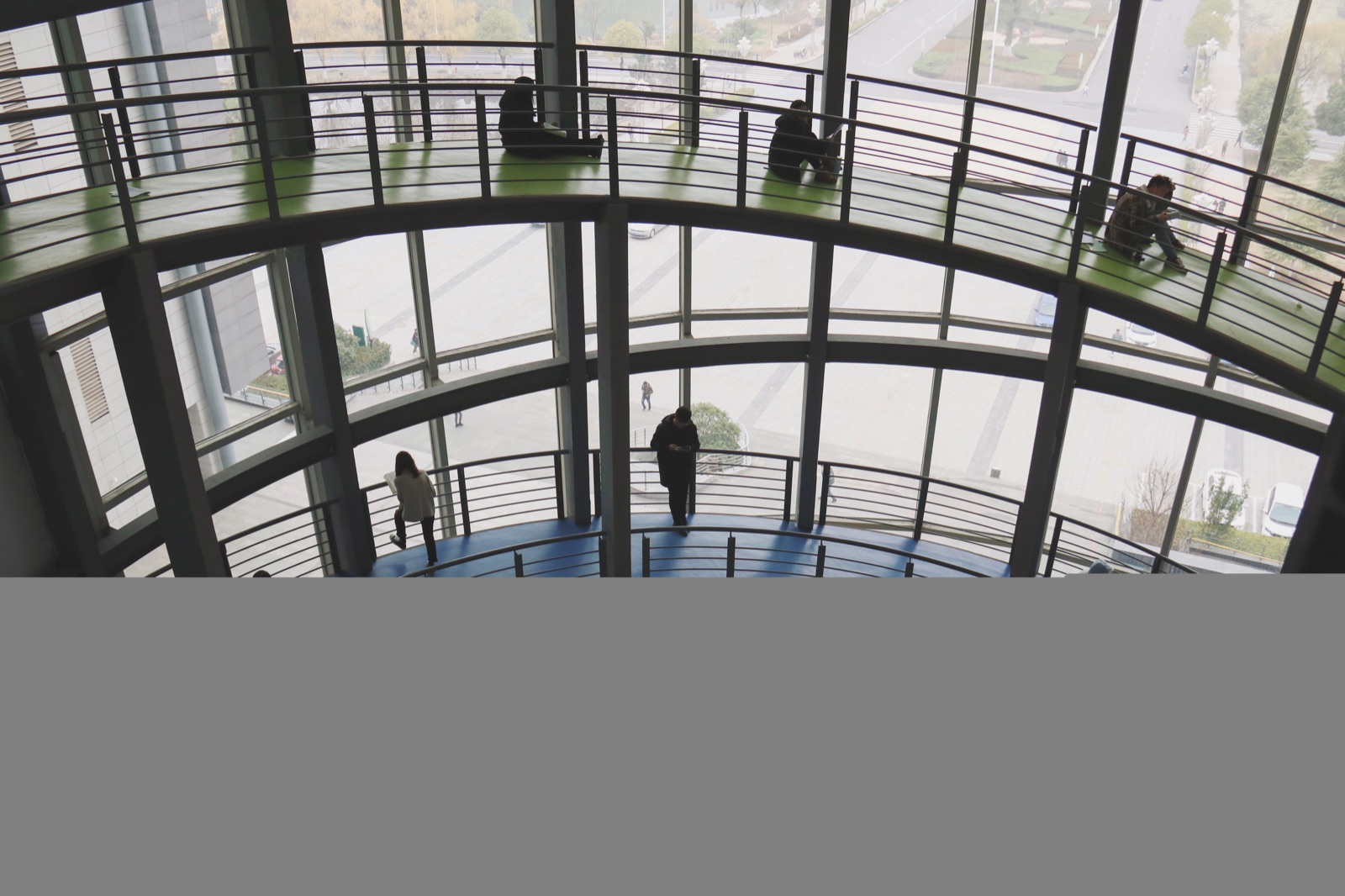 Students studying inside the multi-level Jiangsu University Library