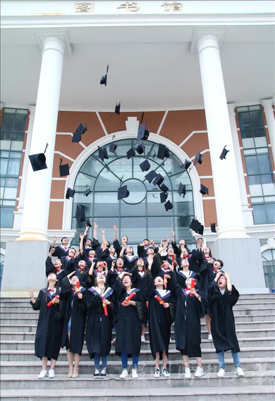 Wenzhou Medical University graduates celebrating outside the university library