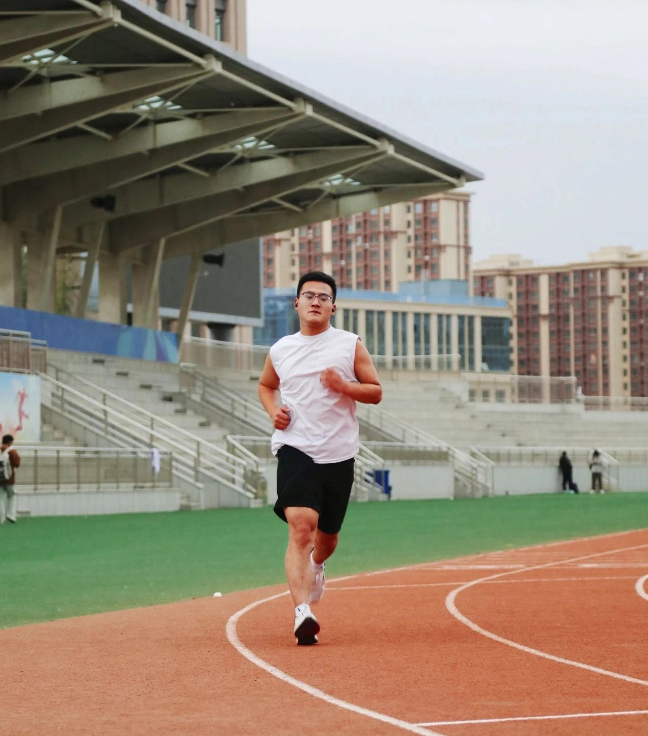 Student running on the athletics track at Xinjiang Medical University